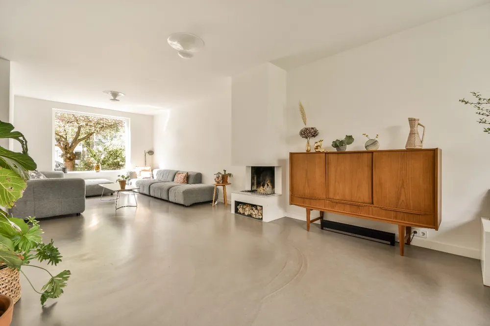 Epoxygulv med struktur i moderne stue med hvide vægge og indbygget pejs